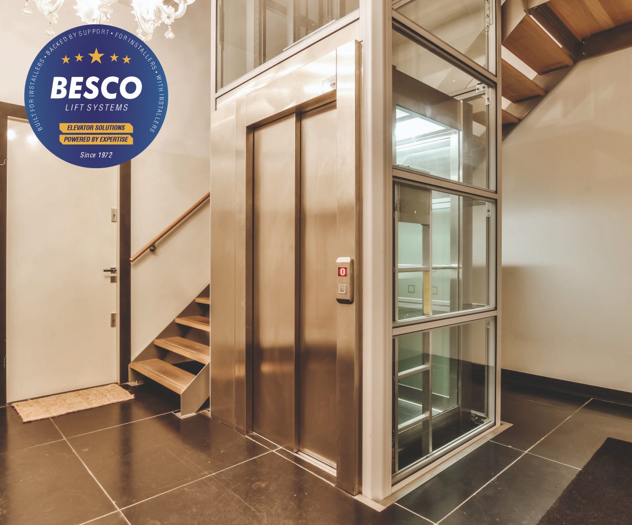 Glass lift beside a staircase